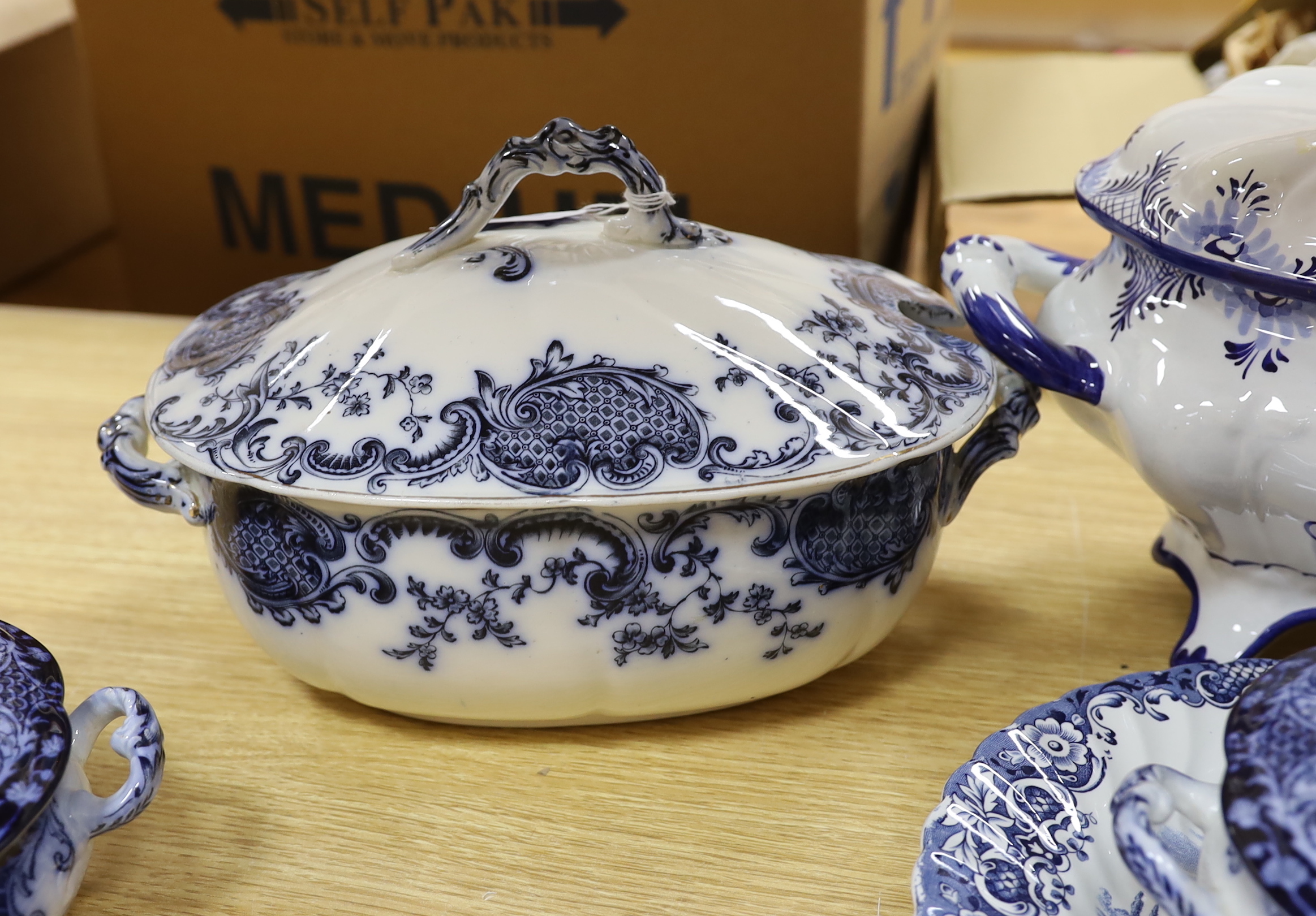 Two blue and white soup tureens and two vegetable tureens and a meat dish